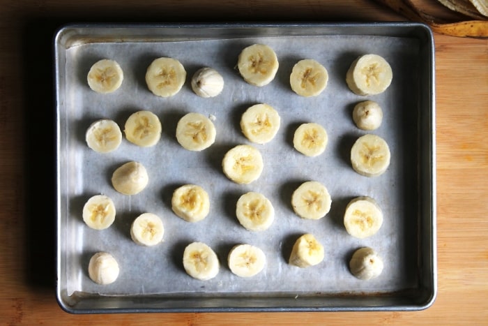 place banana slices on a lined tray before freezing